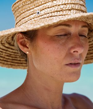 Portrait of mid aged woman with short hair wearing straw hat
